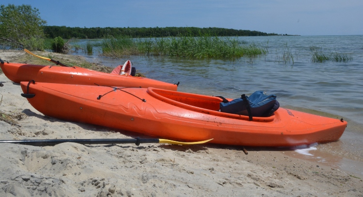 orange kayaks on beach